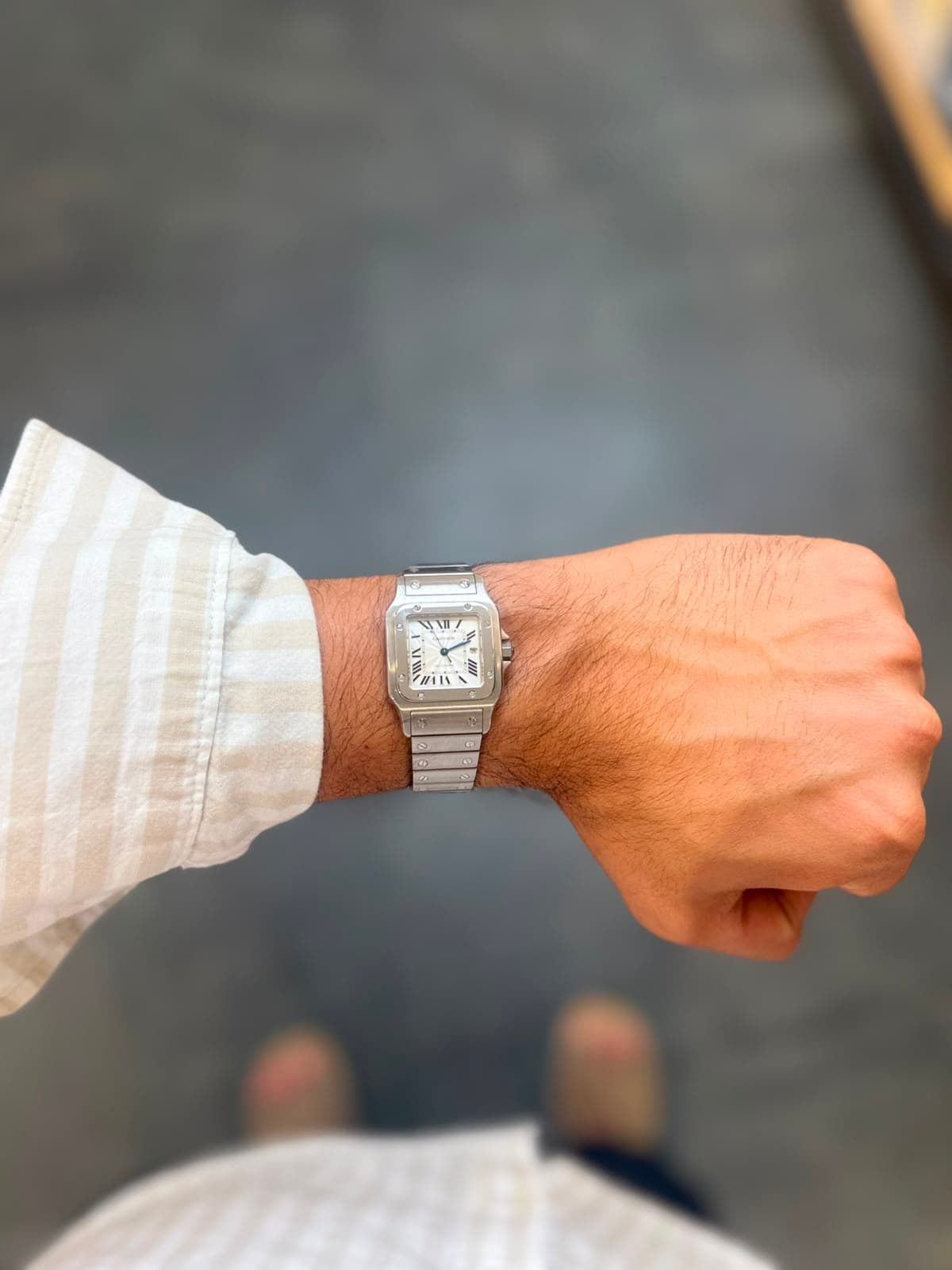 Cartier Santos against a soft gray background