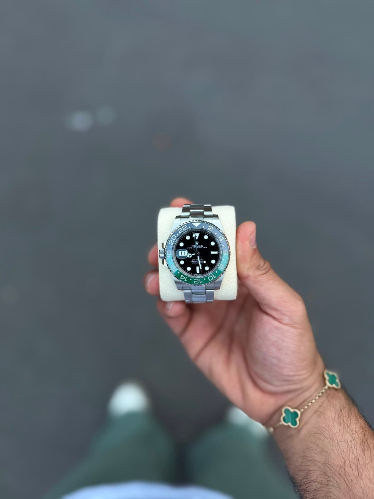 Rolex GMT-Master on dark wet asphalt